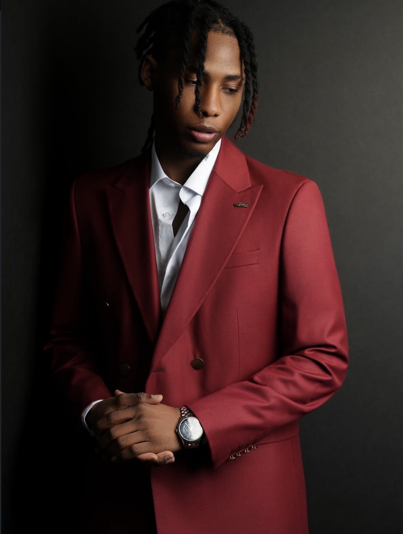 Studio portrait of a man in a tailored red suit on a dark backdrop, New York portrait photography by KB Photography